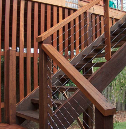 Stained hardwood stairs with cable railing in Dublin
